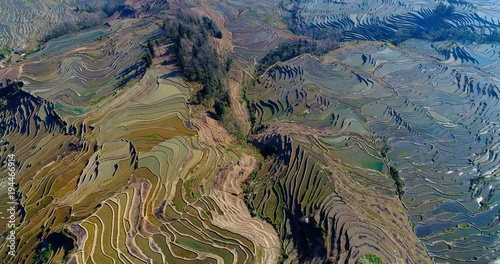 Rice paddies filled with water, creating breathtaking patterns. Aerial view on world's largest and most beautiful Rice Terraces, the Yuanyang Hani Rice Terraces in southeastern Yunnan province, China.