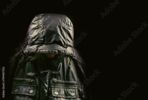 Silhouette of a black jacket with a hood. The concept of mystery, incognito.