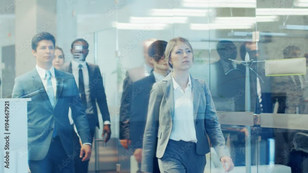 Diverse Team of Delegates/ Lawyers Led by Woman Confidently Marches Through the Corporate Building Hallway. Multicultural Crowd Of Resolute Business People in Stylish Marble and Glass Offices. Diverse Team of Delegates/ Lawyers Led by Woman Confidently Marches Through the Corporate Building Hallway. Multicultural Crowd Of Resolute Business People in Stylish Marble and Glass Offices.