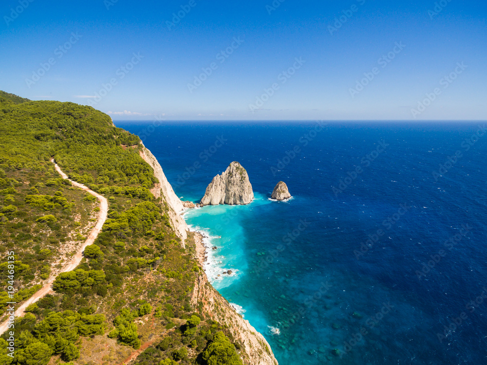 Fototapeta premium Greek biggest national flag waving in the sky in Keri in Zakynthos (Zante) island in Greece