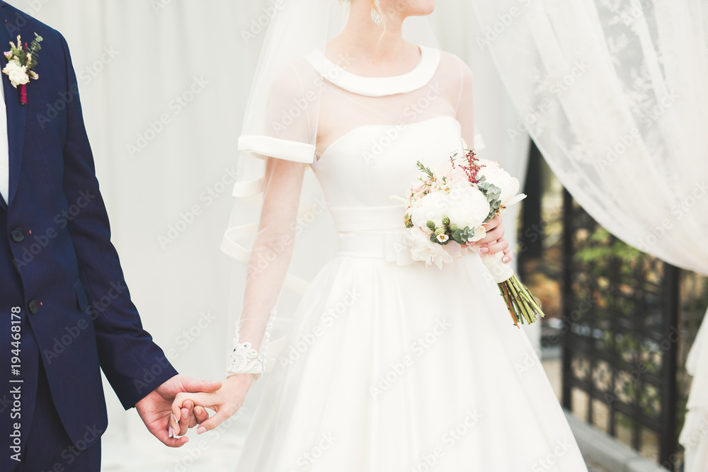 Wedding couple bride and groom holding hands