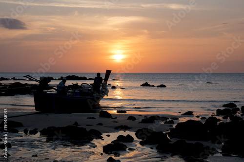 2017-02-02: koh tao island, thailand, fishermen watch the sunset before going to work