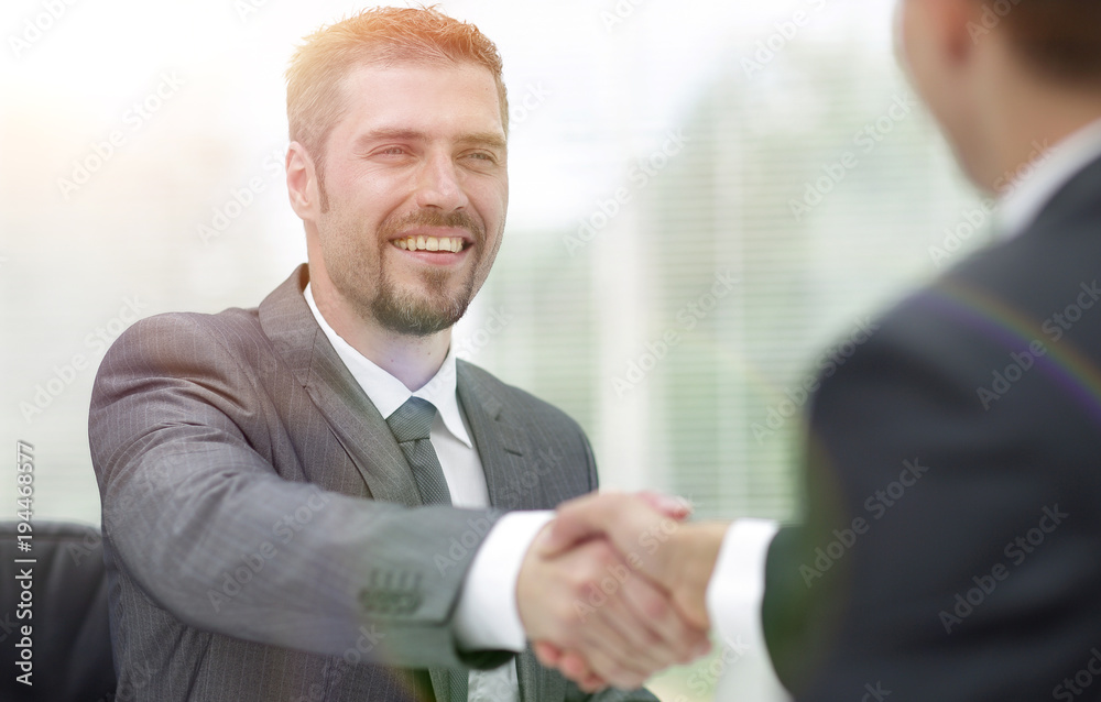 closeup .handshake of business partners on a Desk closeup .handshake of business partners on a Desk