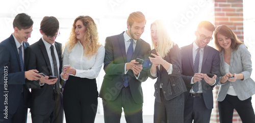 business team looking to smartphone in office