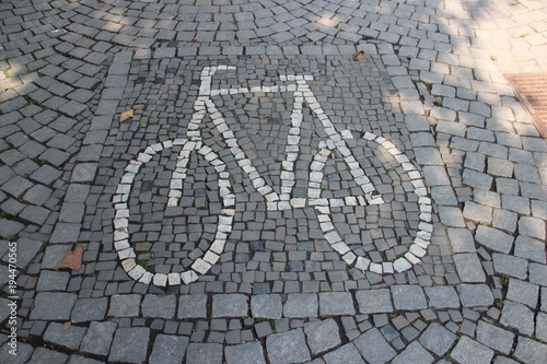 Sidewalk brick design with bicycle zone sign