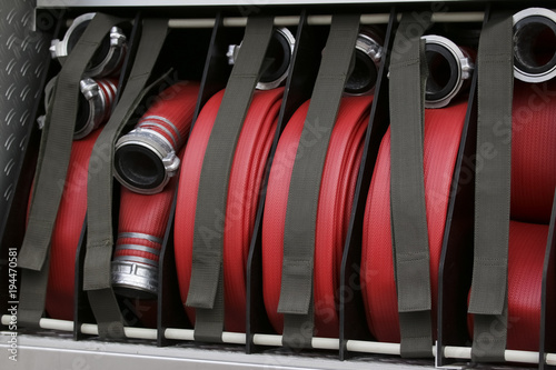 Inside of a fire truck - fire hoses prepared for usage