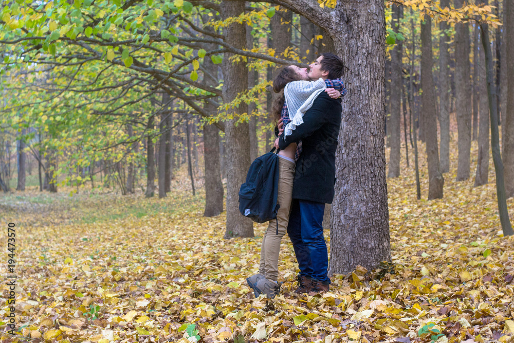 Lovers met in the woods after classes. Happy students firmly hugged.