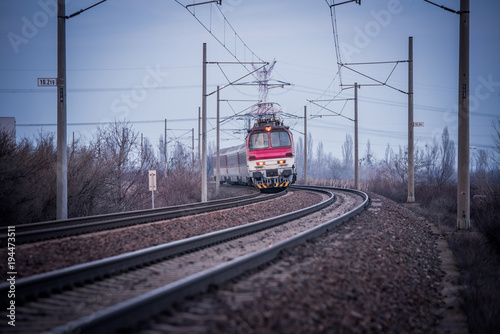 Train ride on the track in dark evening light, travel, transport photo