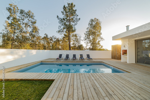 Fényképezés Modern house with garden swimming pool and wooden deck