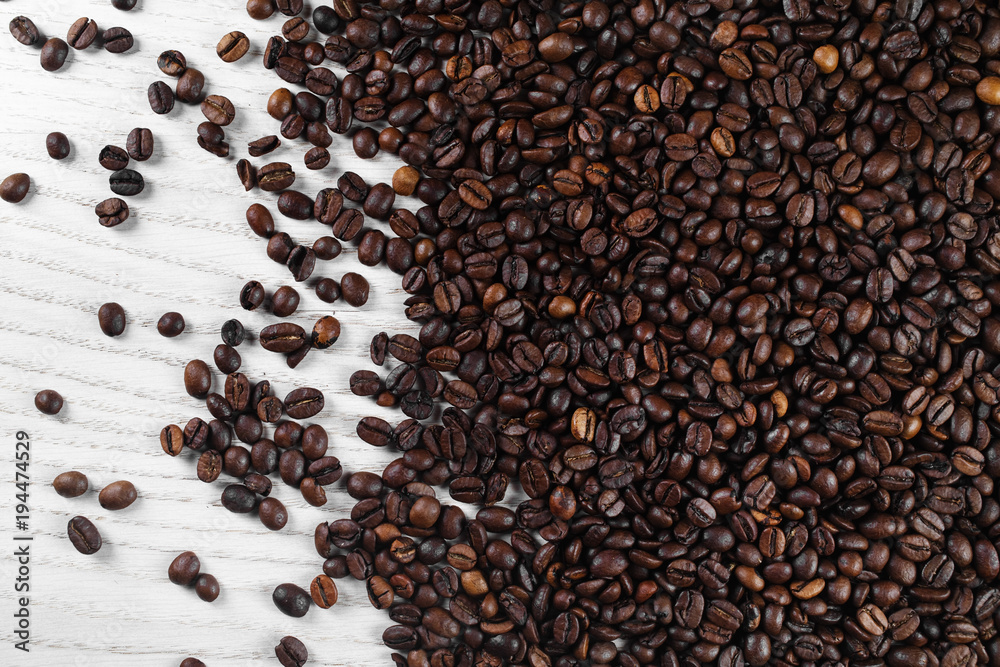 Roasted coffee beans on kitchen table. Top view. Roasted coffee beans on kitchen table. Top view.