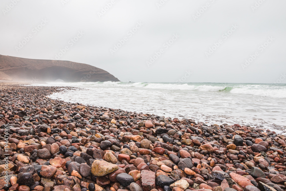 Coast, wave, beach and a large rock Coast, wave, beach and a large rock