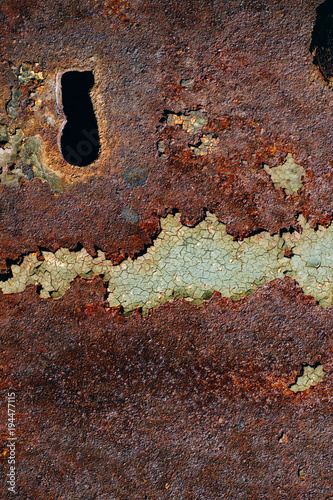texture of rusty iron, cracked green paint on an old metallic surface, metal surface with a bolt and a keyhole