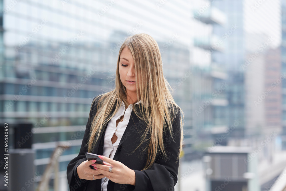 businesswoman talking to mobile in urban environment businesswoman talking to mobile in urban environment