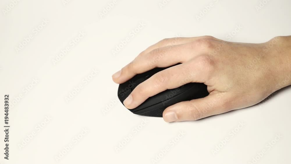 Hand Using Wireless Mouse On A White Surface Hand Using Wireless Mouse On A White Surface