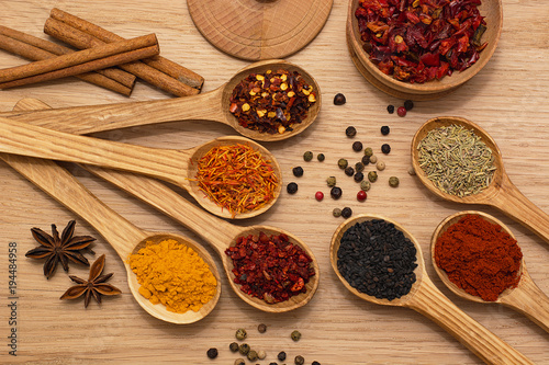 Spice. Spice in a wooden spoon. Herbs. Curry  saffron  turmeric  pepper and others on a wooden background.