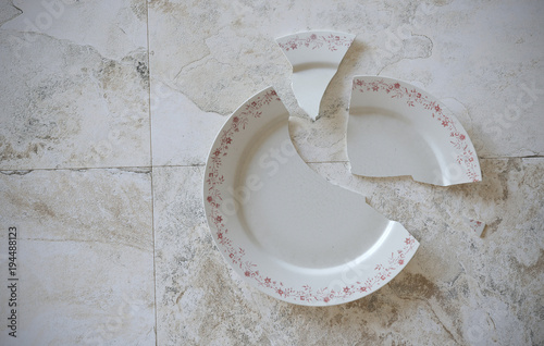 Empty cracked broken plate on grey tiled marble background floor or table. 3d illustration