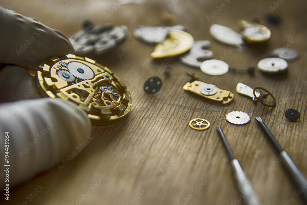 Watchmaker is repairing the mechanical watches in his workshop Watchmaker is repairing the mechanical watches in his workshop