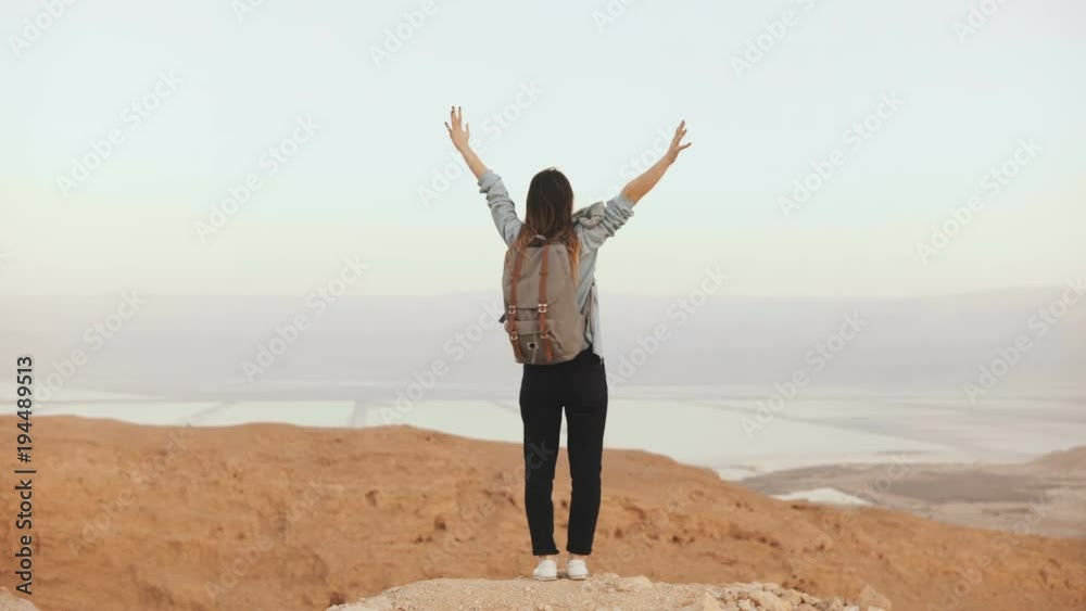 Girl at mountain view, jumping with arms wide open. Pretty European woman happy and excited. Happiness. Israel desert 4K Girl at mountain view, jumping with arms wide open. Pretty European woman happy and excited. Happiness. Israel desert 4K