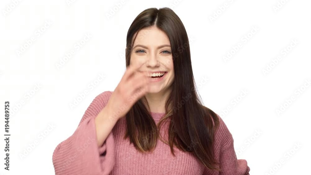 Portrait of gorgeous mature woman 30s with blue eyes laughing and touching her beautiful brown hair, isolated over white background in studio. Concept of emotions Portrait of gorgeous mature woman 30s with blue eyes laughing and touching her beautiful brown hair, isolated over white background in studio. Concept of emotions