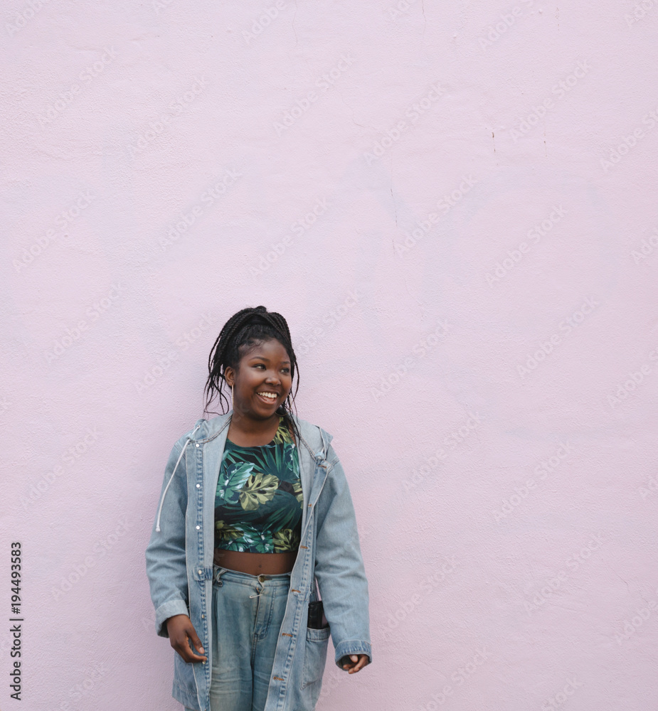 Young woman having fun on pink wall background Young woman having fun on pink wall background