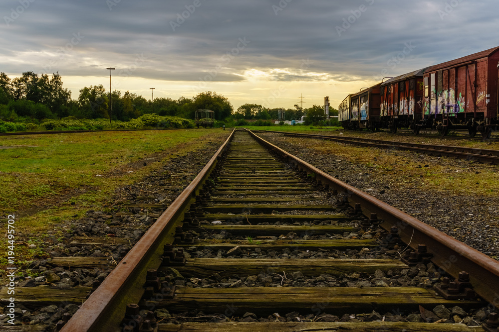 Fototapeta premium dramatic sunset over railroad