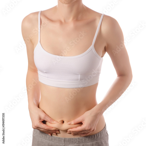 Young beautiful woman in a white T-shirt top of the hand on the belly excess weight of a skin beauty medicine © Kabardins photo