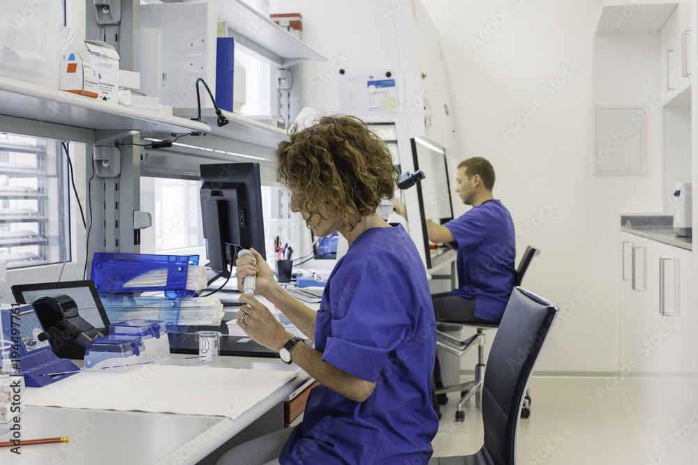 IVF Lab - Profile of Male and Female Lab Technicians Working IVF Lab - Profile of Male and Female Lab Technicians Working