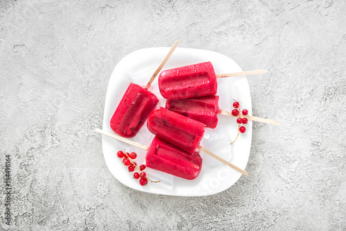 homemade ice-cream popsicles with red currant, topview photo