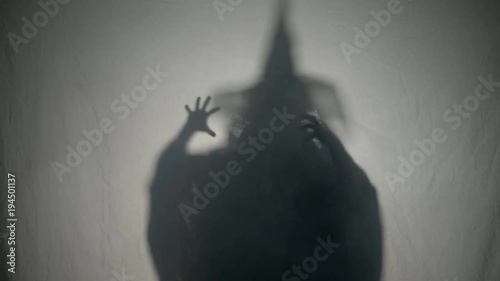 Halloween malefic witch laughing and putting an evil spell on people on halloween day of the dead