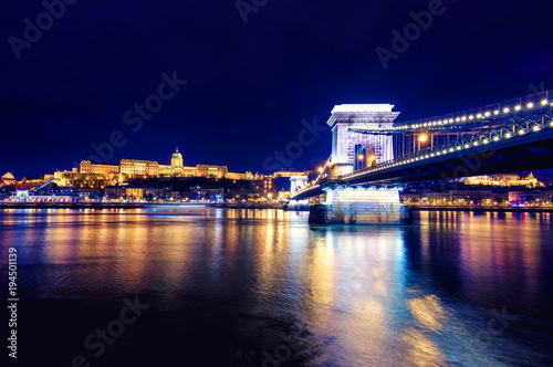 Night view of illuminated Budapest with Danube river, palace and chain bridge, Hungary.
