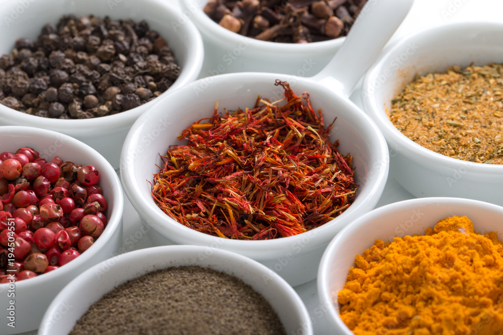 Herbs and spices in ceramic bowls.