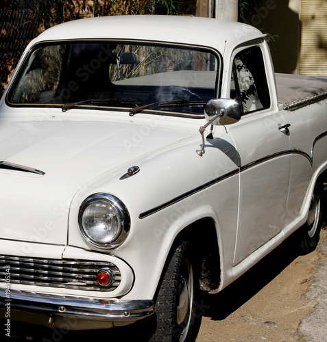 Typical car design of the 60 s. Old white small truck