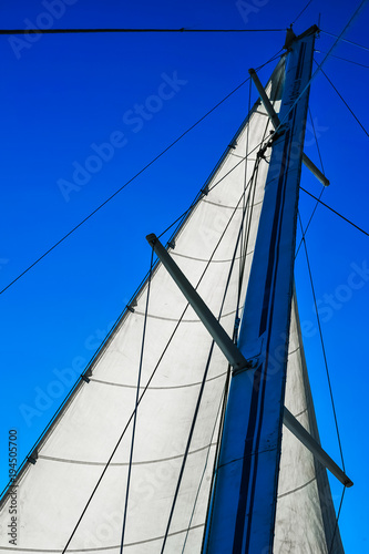 yacht mast head against a blue sky background