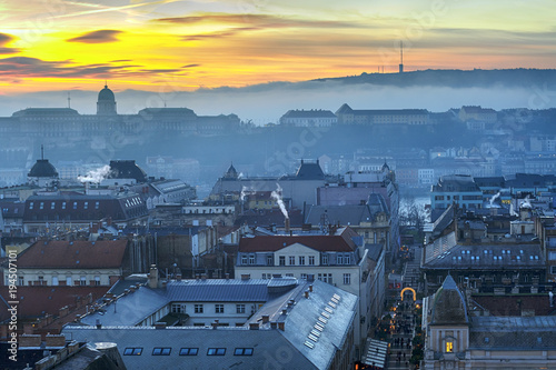 Roofs of Budapest downtown and Royal Castle in fog at sunset