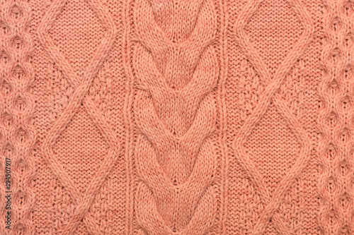 Knitted background. Knitted pink texture. Knitting pattern of wool. Knitting. Background.