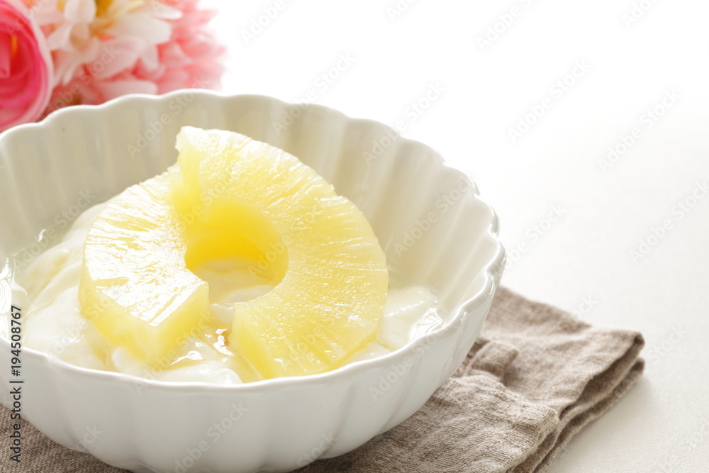 slides of pineapple on yogurt for healthy dessert image
