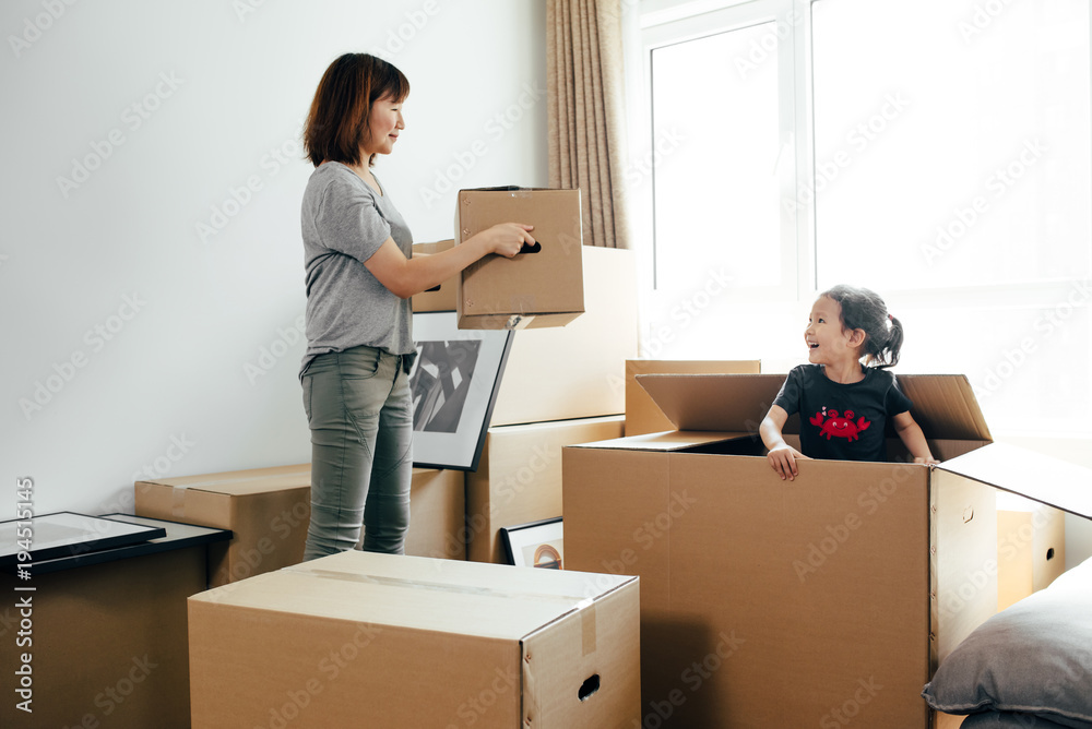 Young woman moving boxes in new home Young woman moving boxes in new home