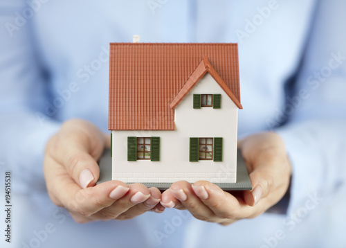 woman holding model of the house