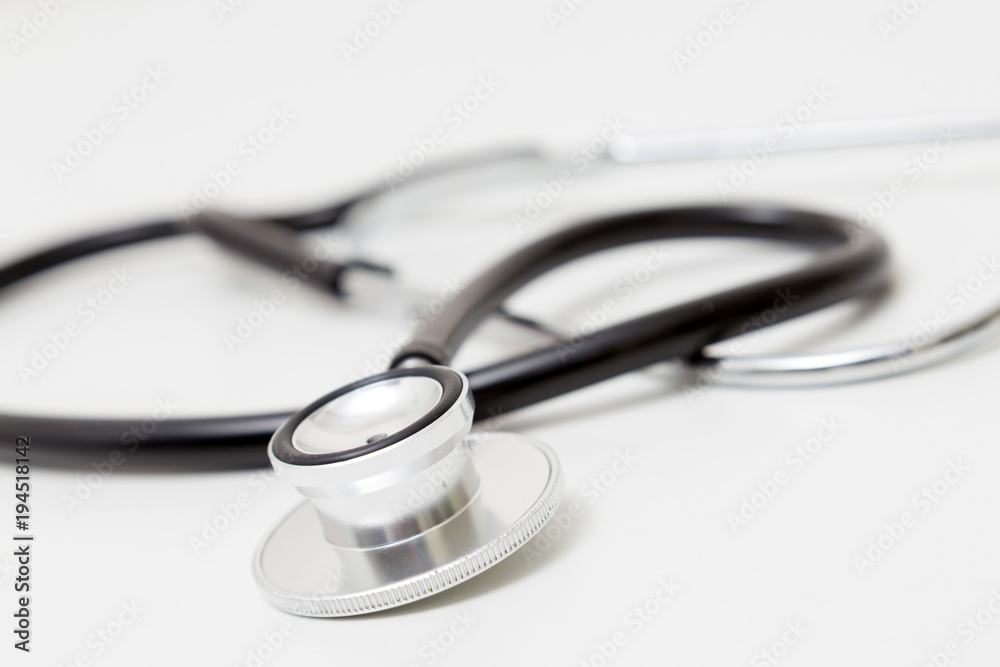 Stethoscope on table. Isolated on white background. Studio lighting. Concept for healthy and medical Stethoscope on table. Isolated on white background. Studio lighting. Concept for healthy and medical