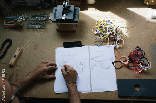 Artisan eyewear designer drawing some glasses designs