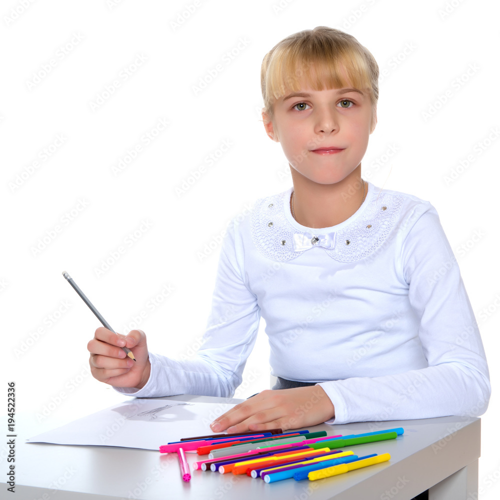 A little girl is drawing at the table. A little girl is drawing at the table.