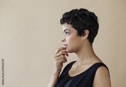 Profile of young woman on beige backfround. photo