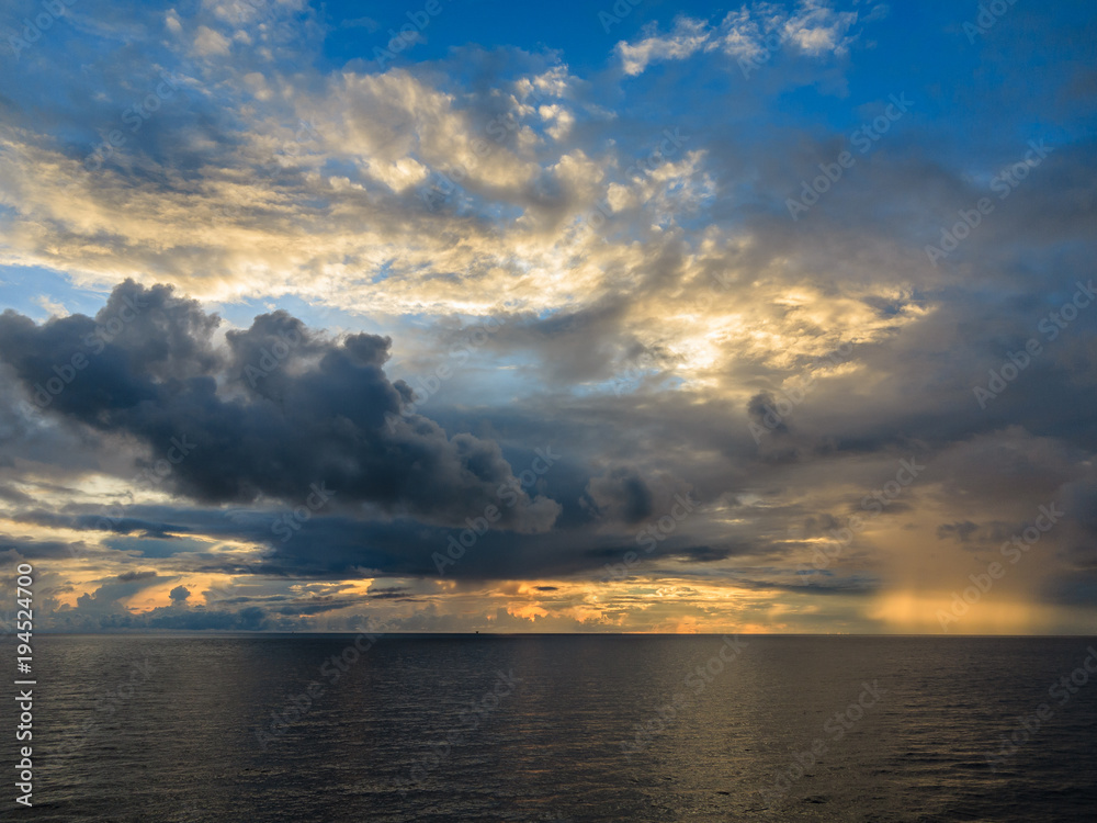 Blue sea and blue sky with white cloud and sunrise up from sea in gulf of Thailand.