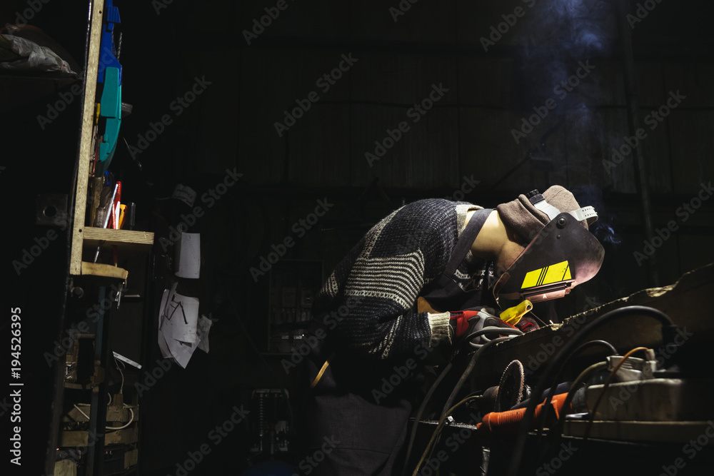Man working on a custom-made motorbike Man working on a custom-made motorbike