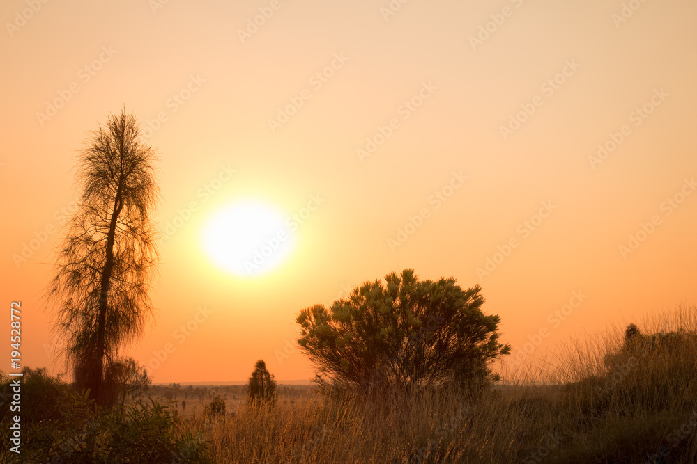 Sunset with smoke haze in the outback of the Northern Territory in Australia