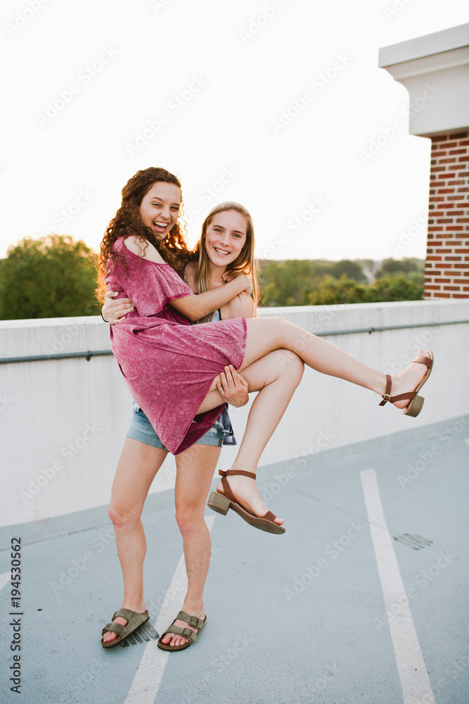 two women being playful and happy two women being playful and happy