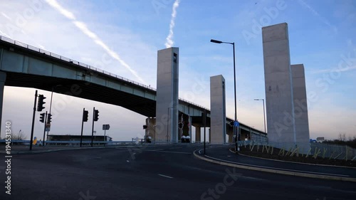 Four concrete pillars of new lifting bridge over river Irwell or Manchester Ship Canal next to M60 motorway photo