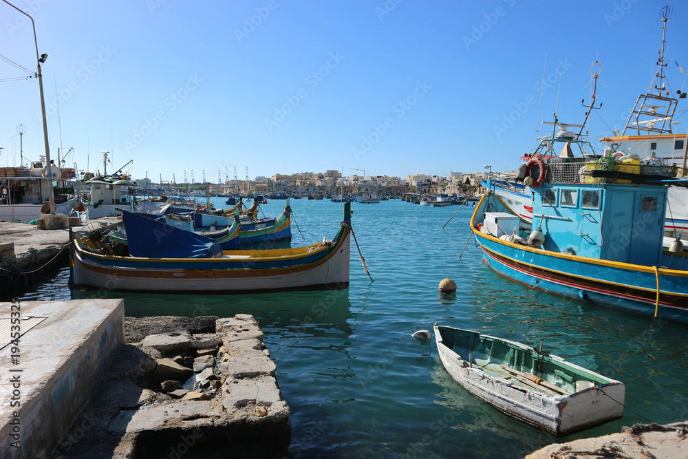 Traditional maltese fisherman boat luzzu in Marsaxlokk bay, Malta