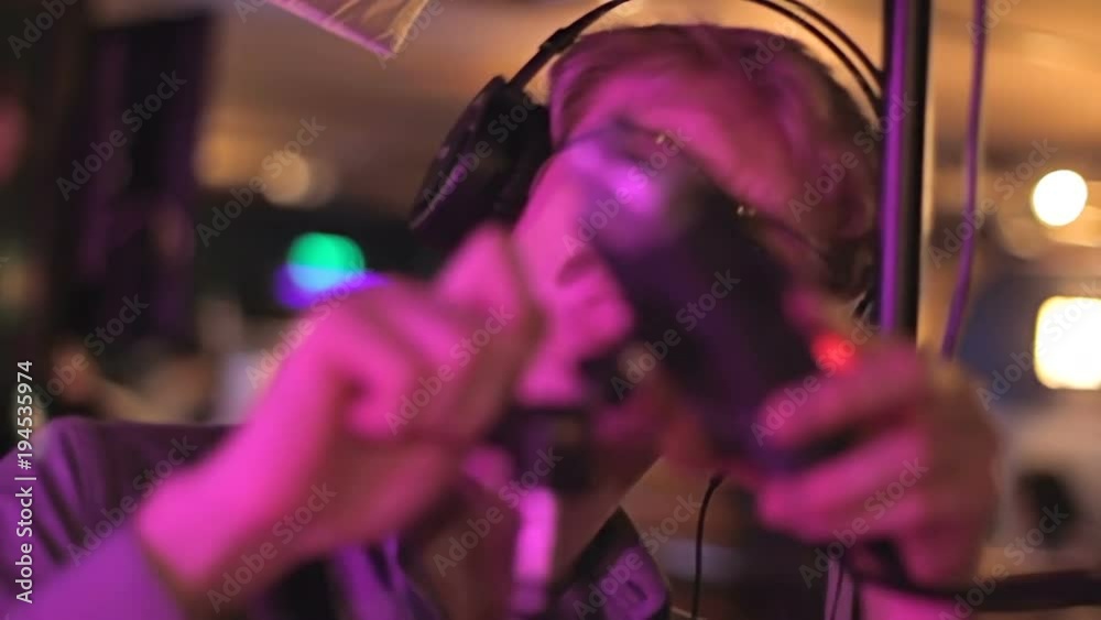 Professional soundman setting up microphone at sound studio, preparing concert