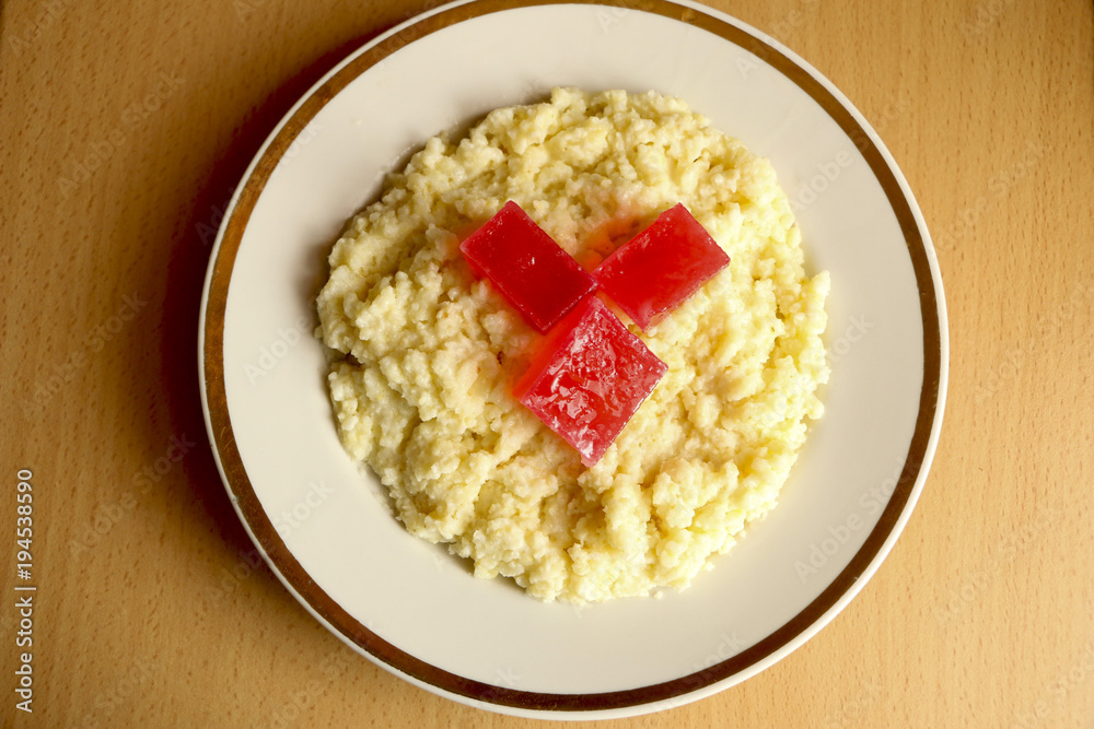 useful breakfast. wheat porridge with marmalade. golden gruel from millet with pieces of fresh fruit jelly. useful breakfast. wheat porridge with marmalade. golden gruel from millet with pieces of fresh fruit jelly.